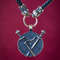 weapon-pendant-on-leather-cord