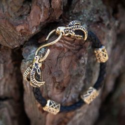 Bracelet on leather braided cord with goat heads and runes. Thor viking bangle. Scandinavian handmade jewelry. Pagan art