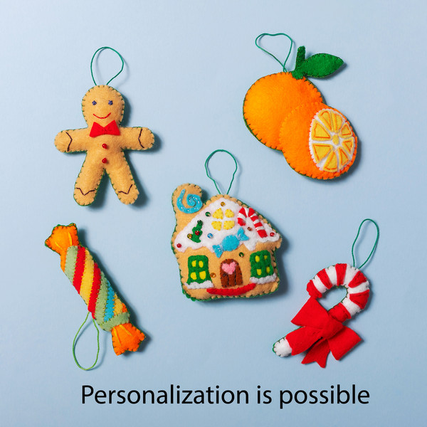 Gingerbread man, tangerines, gingerbread house, cracker and candy cane are made of felt.jpg
