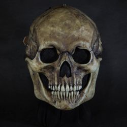 Human skull mask with moving jaw.
