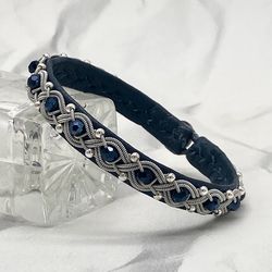 Female Sami leather bracelet with glass and silver beads. A narrow braided bracelet for a woman. Scandinavian jewelry.