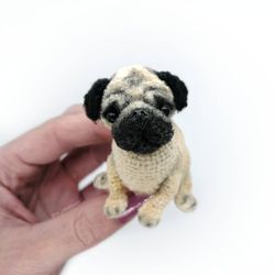 Pug. Miniature little crocheted pug. Cute dog. Amigurumi puppy. Funny pet. A fat dog. A puppy as a souvenir
