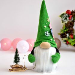 scandinavian christmas gnome with a christmas tree
