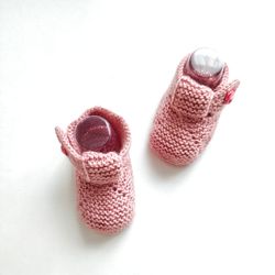 Pink booties baby. Knitted baby shoes.
