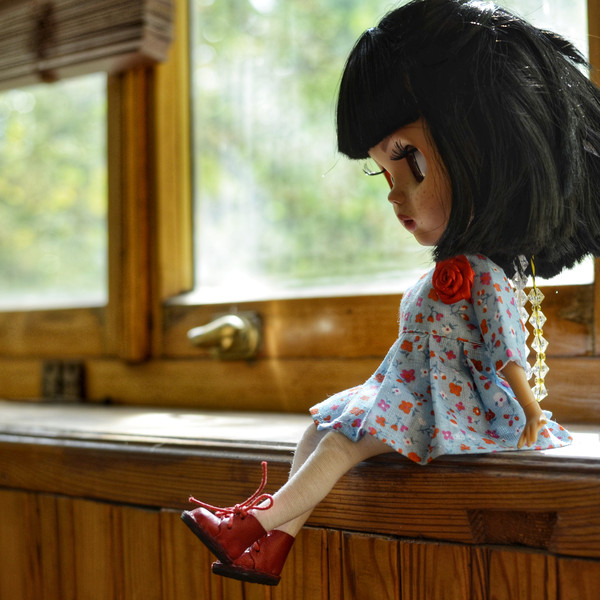 Blythe doll on the windowsill