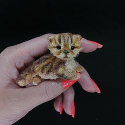 Kitty. A miniature fluffy kitten is a decorative souvenir. Striped cat. A pet as a Gift. Crocheted cat. OxYakutovich