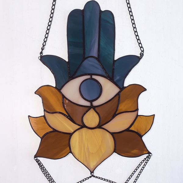 20201108-Stained glass blue Hamsa hand suncatcher with brown and beige lotus flower and black hanging chains on a white background.jpg