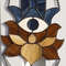 20201108-Stained glass blue hand with eye Hamsa suncatcher with brown and beige lotus flower hanging in front of a white metal fence.jpg