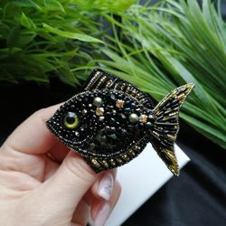 A brooch in the form of a fish, handmade marine jewelry with beads and crystals