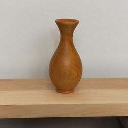 Vase made of apple wood for dried flowers. Interior decor element. Puppet game.