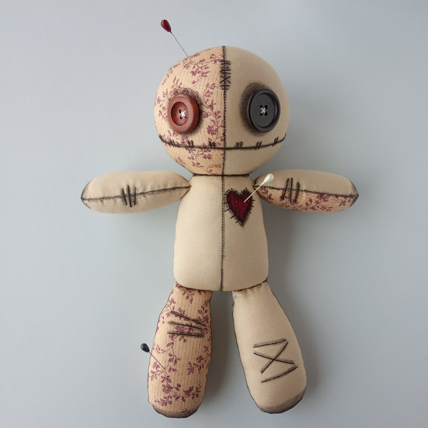 Stuffed-voodoo-doll-with-pins-1