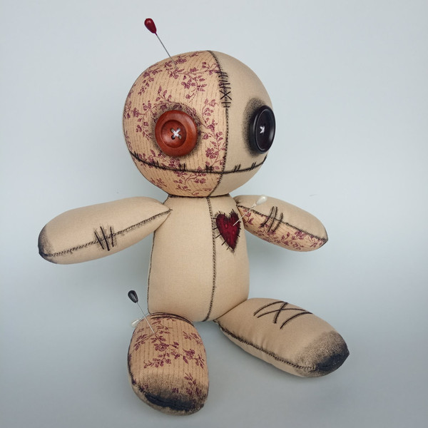 Stuffed-voodoo-doll-with-pins-3