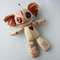 Stuffed-voodoo-doll-with-pins-and-yarn-hair-7