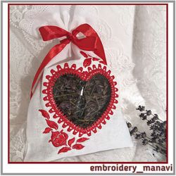 Embroidery design of a heart-shaped window with flowers