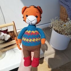Stuffed tiger toy for Christmas gift. Big soft toy tiger in Christmas costume for baby present. Plush tiger toy.