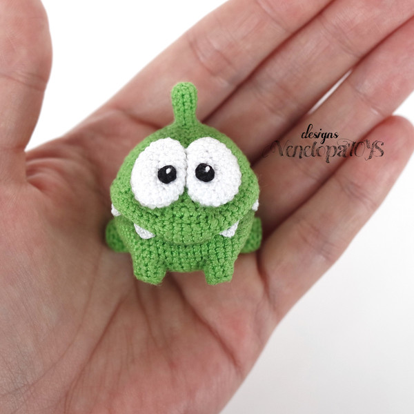 Crocheted Om Nom on the palm