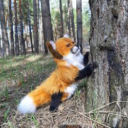 Fox in realistic style.Collectible toy. Fox made of artificial fur. Christmas present.