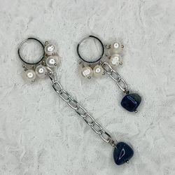 Fashionable original earrings made of natural pearls and blue stone.