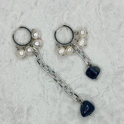 fashionable original earrings made of natural pearls and blue stone.