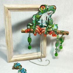 Embroidered tree frog brooch with Czech glass pendants.