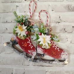 Christmas figure skates decorated with winter decor in red