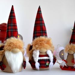 family of three christmas gnomes in hats, christmas table decoration