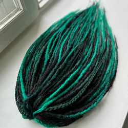Dark green synthetic dreads and braids