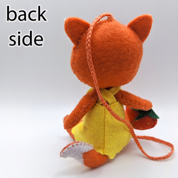 A ginger fox made of felt. View from the back.jpg