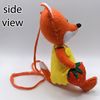 A ginger fox sewn by hand holds a strawberry berry in its paw.jpg