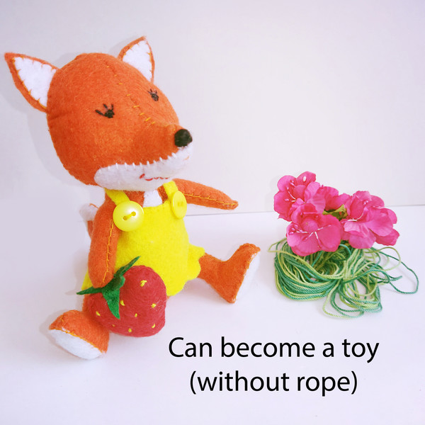 stuffed fox sits near a bouquet of flowers.jpg