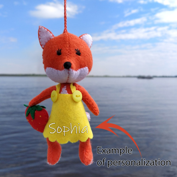 A toy soft fox in a yellow dress with hand-embroidered eyes.jpg