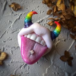 Pearl brooch with rainbow horns and tongue piercing