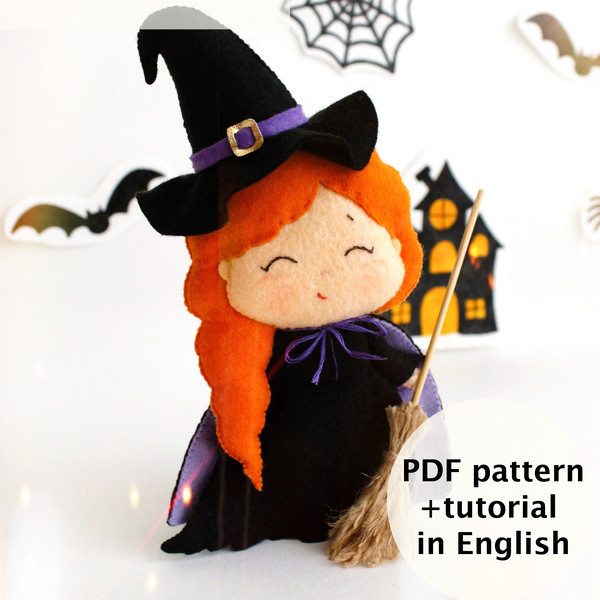 Felt Halloween toy - witch in the pointed hat with a broomstick standing in the background of painted Halloween decorations
