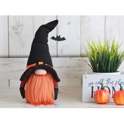 Halloween gnome in a witch's hat with a bat