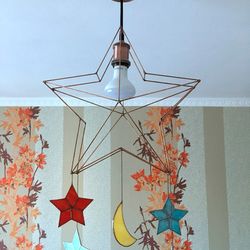 Star lamp in the children's room with stained glass stars