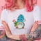 portrait-of-young-amazed-beautiful-pink-haired-lady-with-tattooed-hands-wears-in-white-t-shirt-blows-gum-ball-looking-to-the-left-in-surprise-stands-with-copy-s