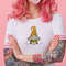 portrait-of-young-amazed-beautiful-pink-haired-lady-with-tattooed-hands-wears-in-white-t-shirt-blows-gum-ball-looking-to-the-left-in-surprise-stands-with-copy-s