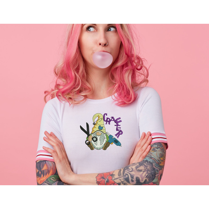 portrait-of-young-amazed-beautiful-pink-haired-lady-with-tattooed-hands-wears-in-white-t-shirt-blows-gum-ball-looking-to-the-left-in-surprise-stands-with-copy-s