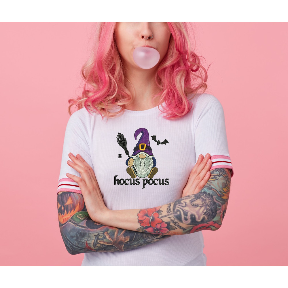 portrait-of-young-amazed-beautiful-pink-haired-lady-with-tattooed-hands-wears-in-white-t-shirt-blows-gum-ball-looking-to-the-left-in-surprise-stands-with-copy-s