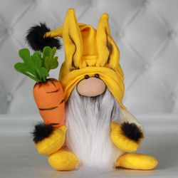 Plush yellow Gnome Rabbit. A soft stuffed toy Gnome with a carrot.