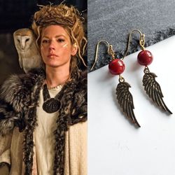 Viking earrings for women. Gold-colored earrings with bird and carnelian wings in the Scandinavian style.