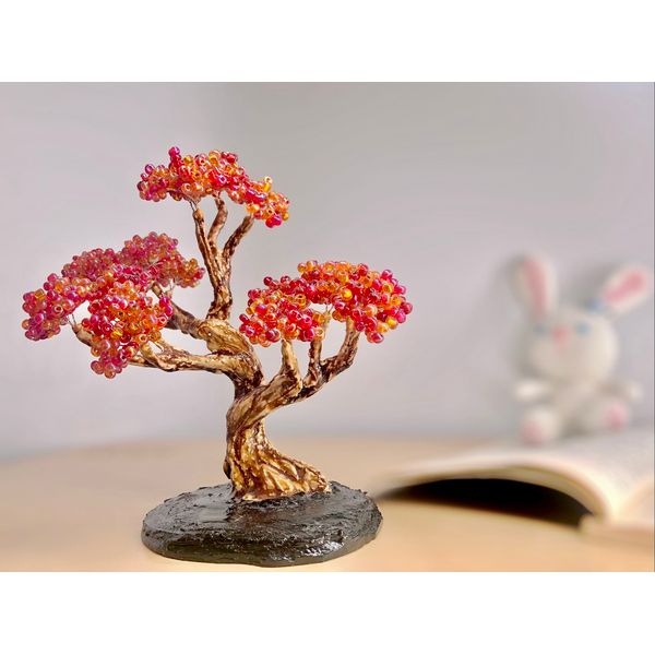 Realistic-mini-tree-decor-bonsai-on-a-pastel-background-with-an-open-book.jpeg