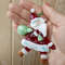 santa claus christmas glass decoration in the palm.jpg
