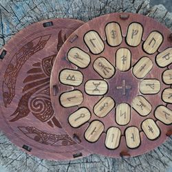 Icelandic rune set. Viking runes in the round box with ravens. Norse pagan runes. Set of wooden runes