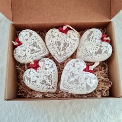 White hearts shape ornaments set with red ribbon