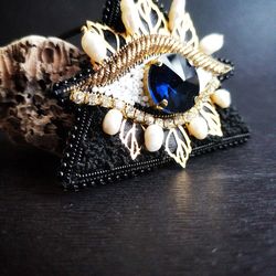 Embroidered triangular brooch-pendant from the Evil Eye with pearls