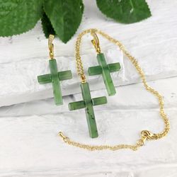 Set of earrings and pendant cross made of green natural jade, religious and spiritual jewelry.