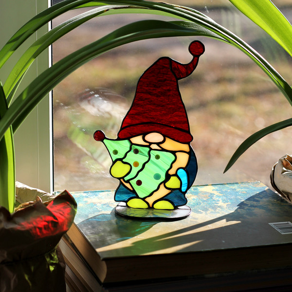 Handmade-stained-glass-sun-catcher-8"-on-stand-gnome-with-a-Christmas-tree-in-his-hands-red-cap-on-his-head-large-blond-beard-blue-coat-green-mittens-and-boots