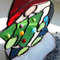 Christmas-tree-made-of-green-glass-and-glued-to-it-Christmas-balls-made-of-glass-drops-of-different-colors-Enlarged-fragment-of-a-stained-glass-suncatcher-gnome