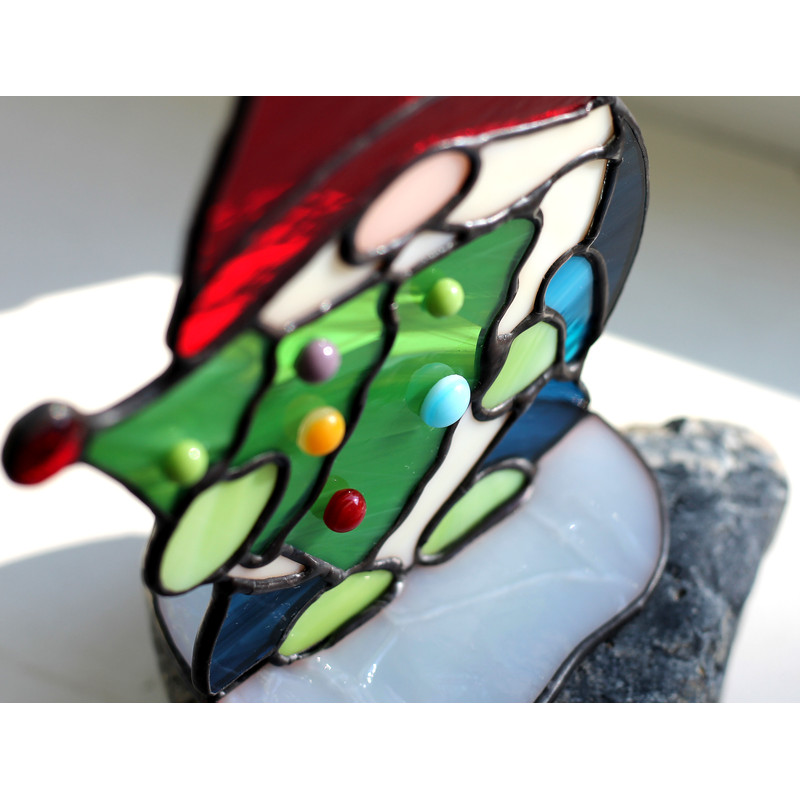 Christmas-tree-made-of-green-glass-and-glued-to-it-Christmas-balls-made-of-glass-drops-of-different-colors-Enlarged-fragment-of-a-stained-glass-suncatcher-gnome